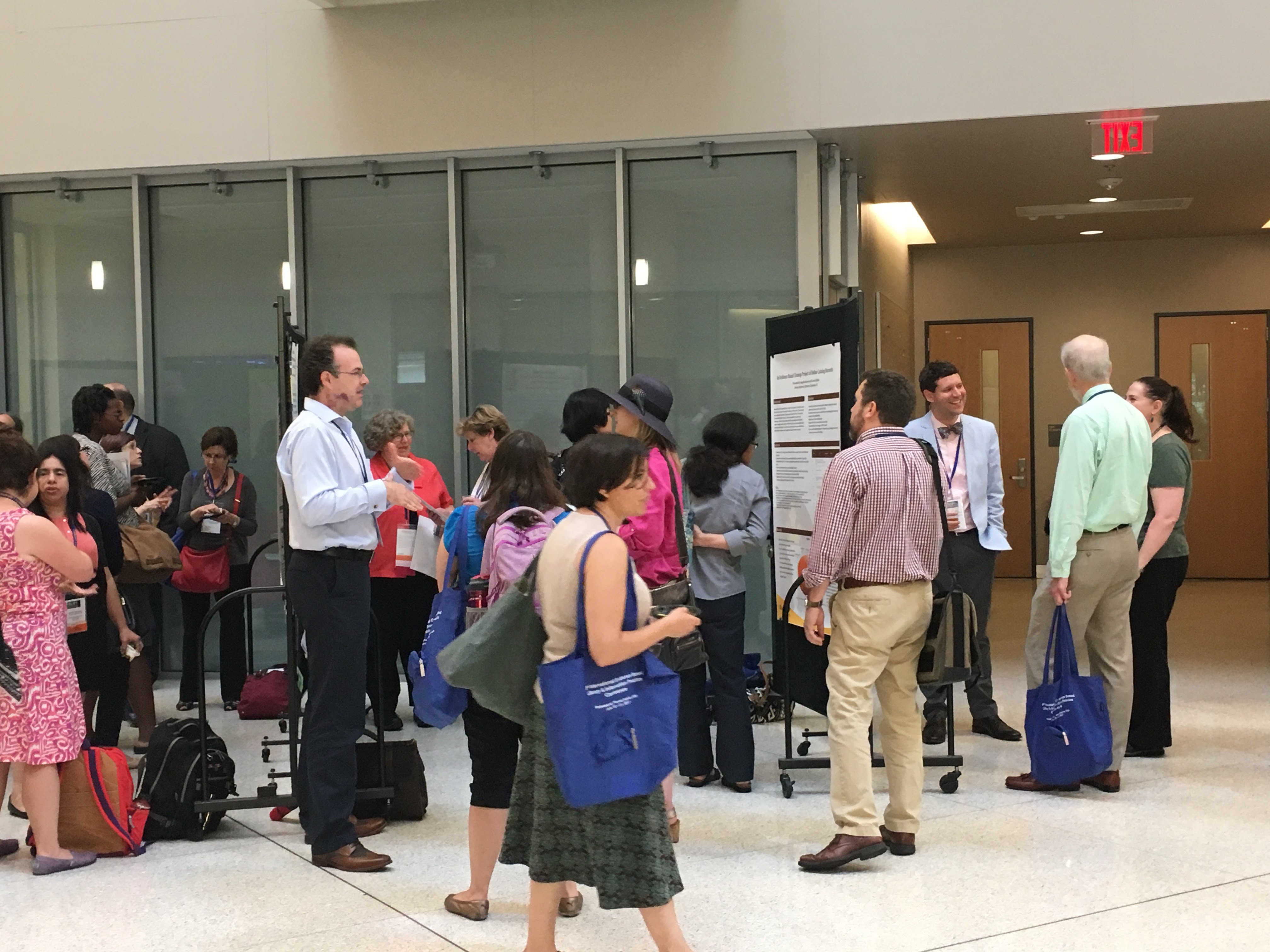 Conference attendees examine poster sessions in the PISB atrium during EBLIP9